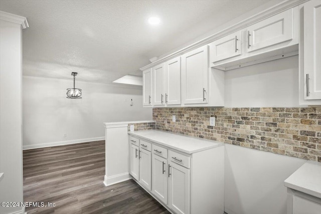 kitchen with tasteful backsplash, white cabinets, pendant lighting, and dark hardwood / wood-style floors