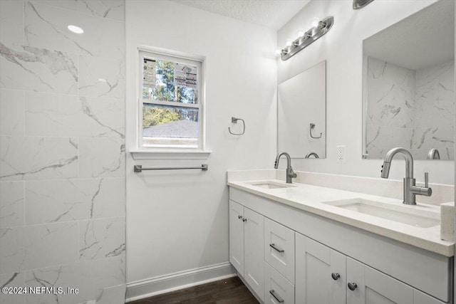 bathroom featuring hardwood / wood-style floors, vanity, and a textured ceiling