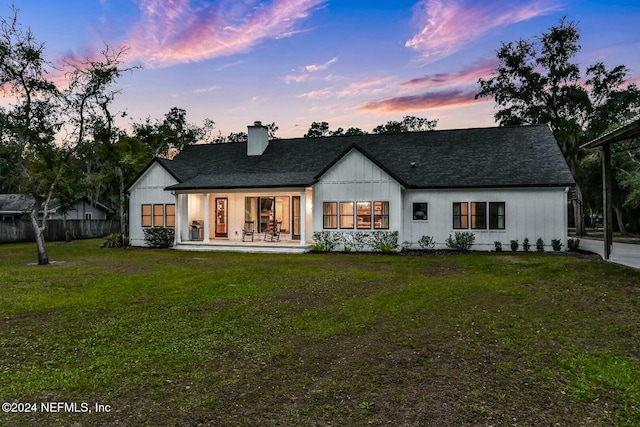 back house at dusk with a yard