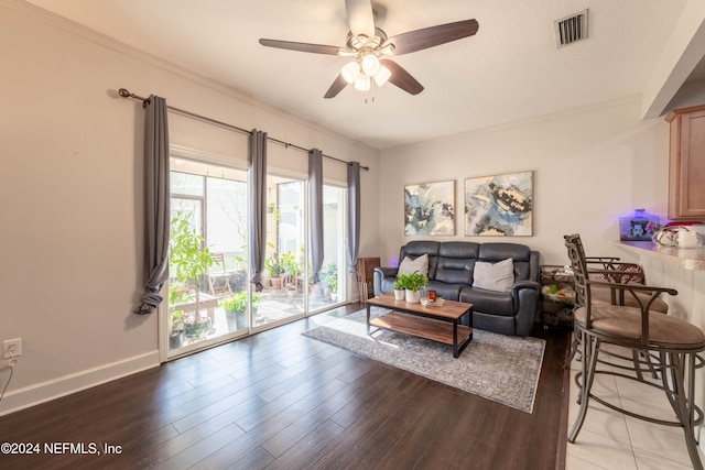 living room with light hardwood / wood-style flooring, ceiling fan, and crown molding