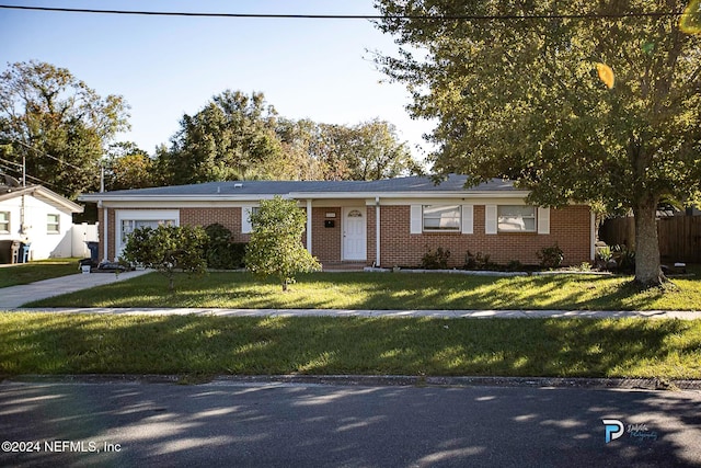 ranch-style home with a front lawn