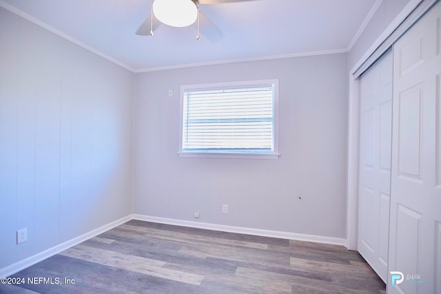 unfurnished bedroom featuring a closet, ceiling fan, dark hardwood / wood-style flooring, and ornamental molding