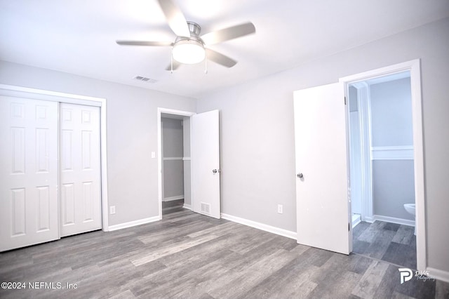 unfurnished bedroom with a closet, ceiling fan, hardwood / wood-style floors, and ensuite bathroom