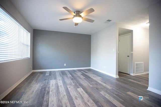 empty room featuring ceiling fan and dark wood-type flooring