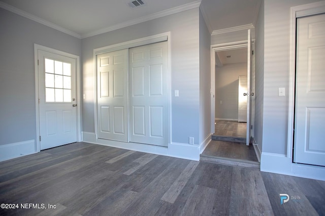 foyer with dark hardwood / wood-style flooring and ornamental molding