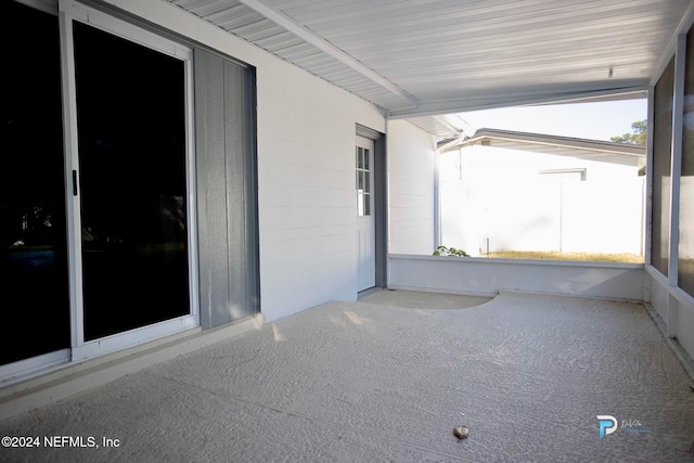 unfurnished sunroom featuring vaulted ceiling