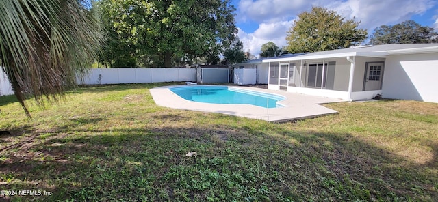 view of pool featuring a sunroom and a yard