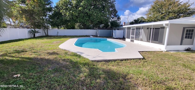 view of pool featuring a lawn and a sunroom