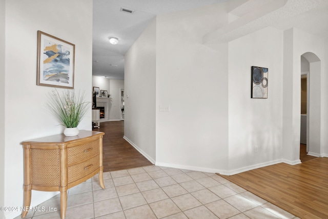 corridor featuring wood-type flooring and a textured ceiling