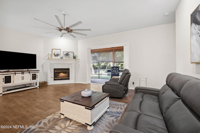 living room featuring hardwood / wood-style floors and ceiling fan