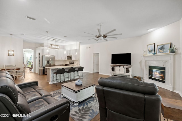 living room featuring hardwood / wood-style flooring and ceiling fan