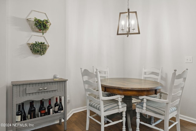 dining area with an inviting chandelier and dark wood-type flooring