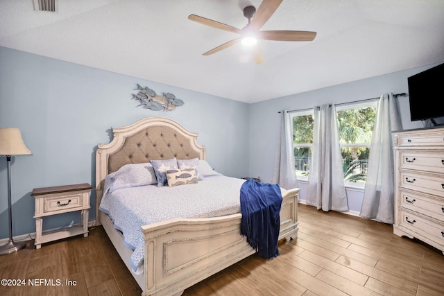 bedroom with dark hardwood / wood-style flooring and ceiling fan