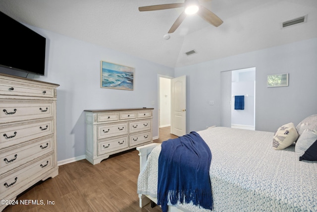 bedroom featuring hardwood / wood-style floors, vaulted ceiling, and ceiling fan