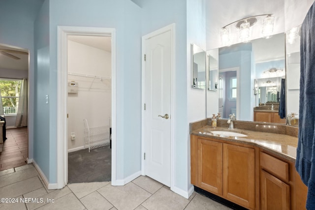 bathroom featuring ceiling fan, tile patterned flooring, and vanity