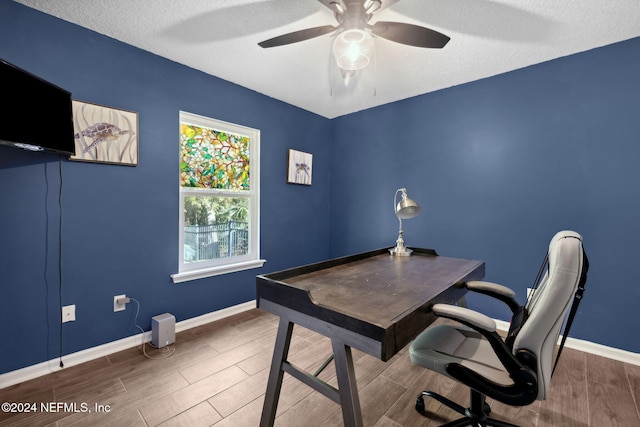 office space with ceiling fan, wood-type flooring, and a textured ceiling