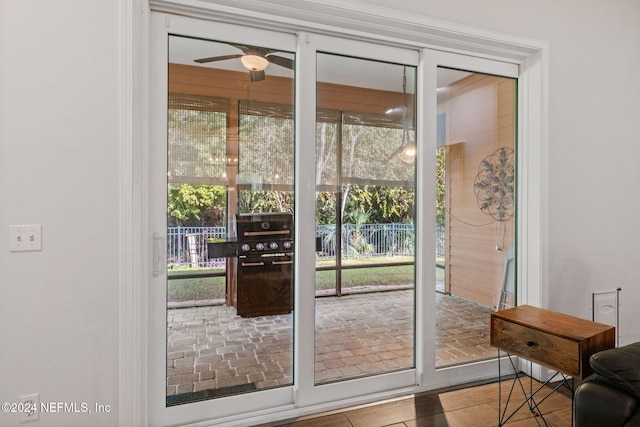 doorway to outside with ceiling fan