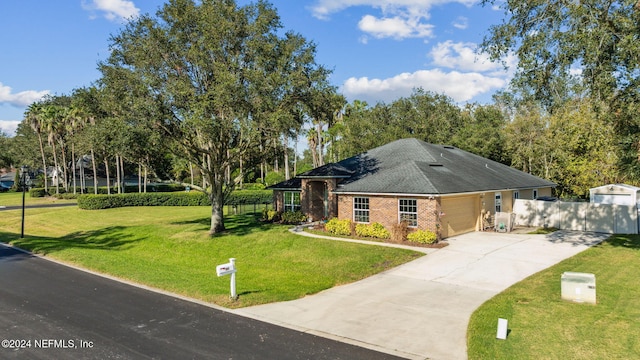 view of front of house featuring a garage and a front lawn