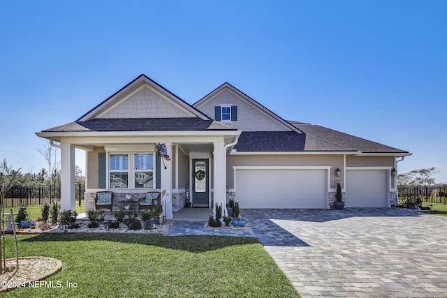 craftsman-style house with a garage and a front lawn