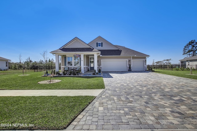 view of front of house with a front lawn, a porch, and a garage