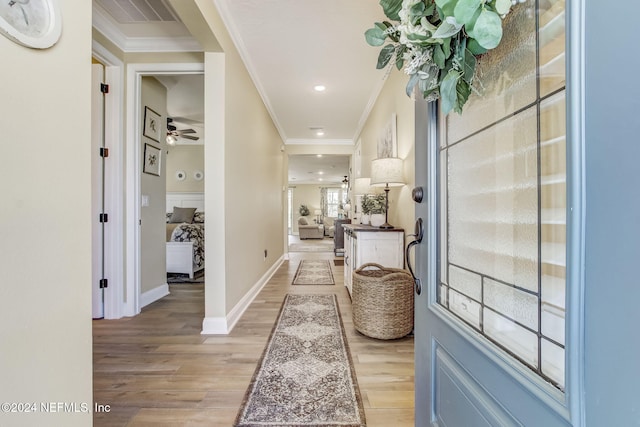 hall featuring light wood-type flooring and ornamental molding