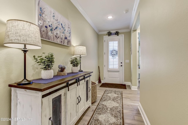 doorway to outside with light hardwood / wood-style floors and ornamental molding