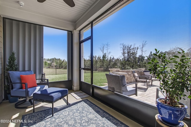 sunroom / solarium featuring ceiling fan