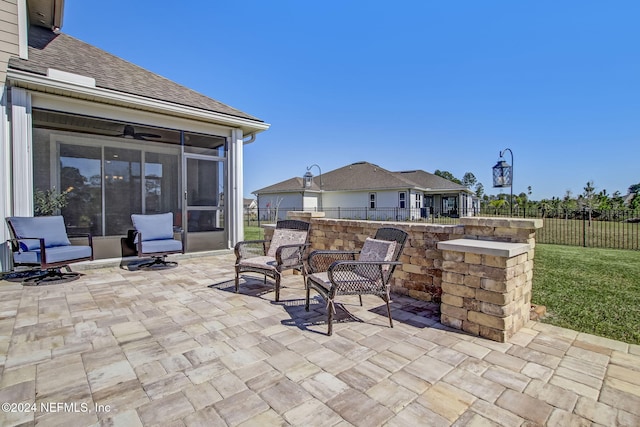 view of patio / terrace featuring a sunroom