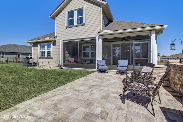 back of property featuring a lawn, central AC, a sunroom, and a patio