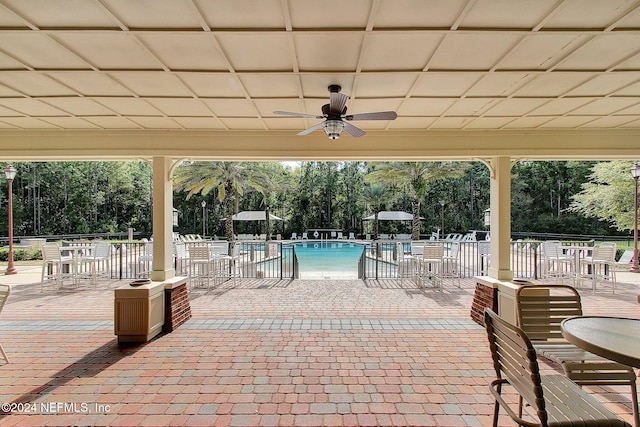 view of patio / terrace with ceiling fan and a community pool