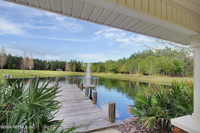 dock area with a yard and a water view