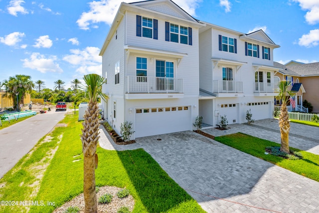 view of property with a garage and a front lawn