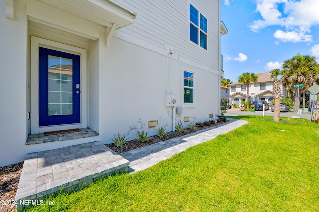 property entrance with a yard