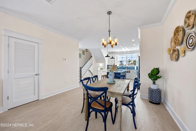 dining space featuring light hardwood / wood-style flooring, a notable chandelier, and ornamental molding