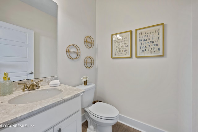 bathroom featuring hardwood / wood-style floors, vanity, and toilet