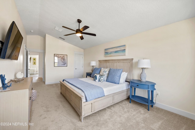 bedroom featuring a textured ceiling, light colored carpet, ceiling fan, and lofted ceiling