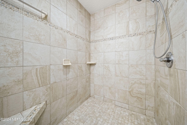 bathroom featuring a tile shower