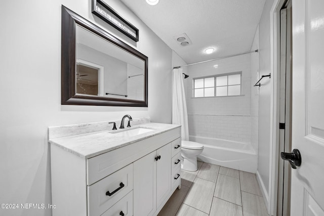 full bathroom featuring vanity, toilet, a textured ceiling, and shower / tub combo