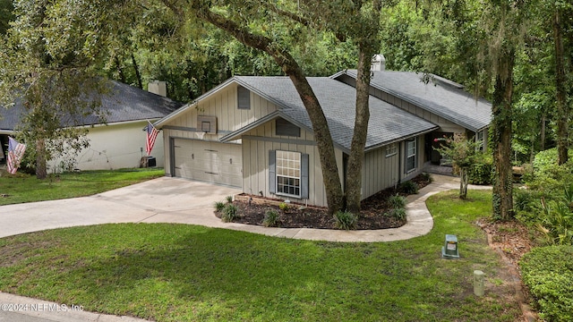 view of front of house featuring a garage and a front lawn