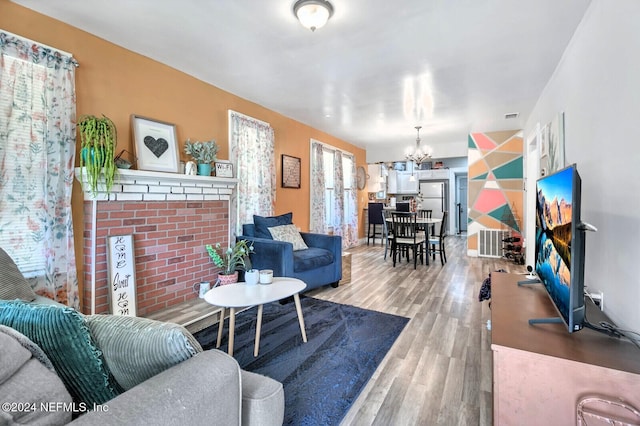 living room featuring a chandelier and hardwood / wood-style floors