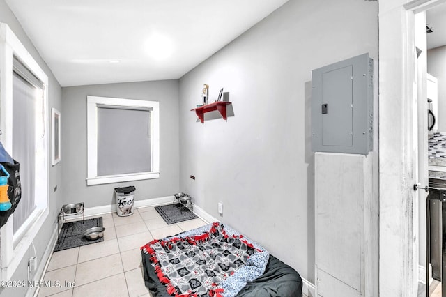 bathroom with tile patterned floors, electric panel, and lofted ceiling