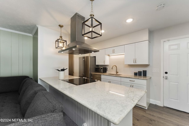 kitchen featuring sink, hanging light fixtures, stainless steel appliances, white cabinets, and island exhaust hood