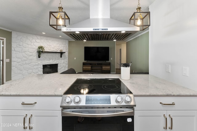 kitchen with pendant lighting, island range hood, stainless steel range with electric cooktop, and white cabinets