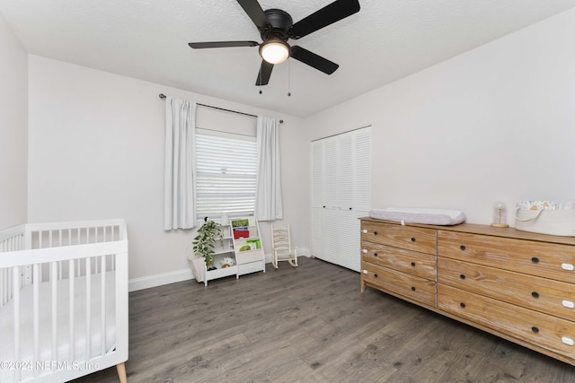 bedroom featuring radiator, dark hardwood / wood-style flooring, ceiling fan, a textured ceiling, and a closet