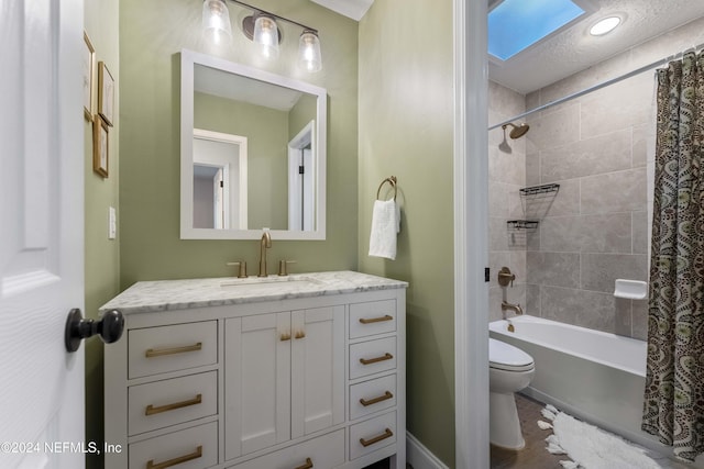 full bathroom featuring vanity, toilet, a skylight, and shower / bath combo with shower curtain