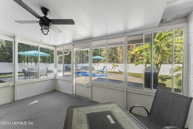 unfurnished sunroom with ceiling fan and a healthy amount of sunlight