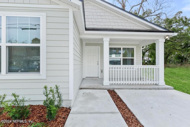 doorway to property featuring covered porch