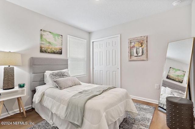 bedroom featuring hardwood / wood-style floors and a closet