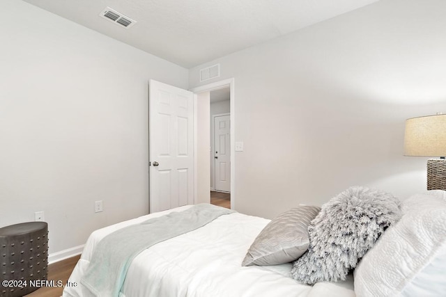 bedroom featuring dark hardwood / wood-style floors