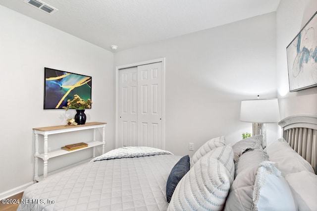 bedroom with hardwood / wood-style floors and a closet